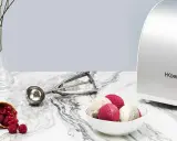 La turbine à glace Koenig HF340 prépare de délicieuses glaces maison. Une cuillère à glace et des fruits rouges complètent la scène.