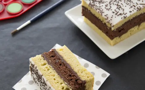Une tranche de gâteau napolitain, digne du meilleur pâtissier, avec une palette de peinture et un pinceau.