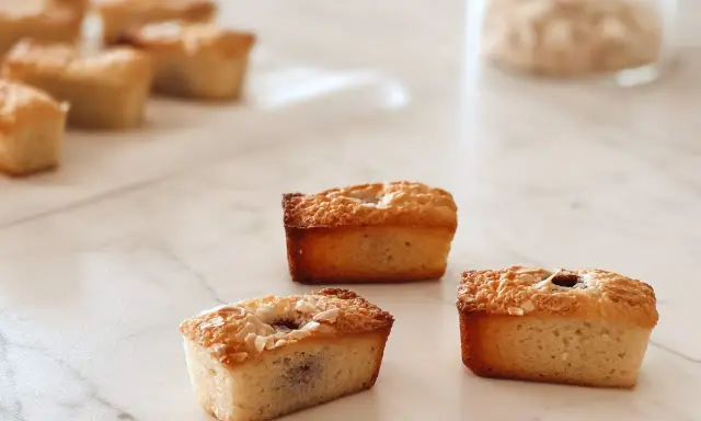 Financiers dorés, parfaits après une cuisson à chaleur tournante. Ils sont garnis de fruits et de noix de coco râpée.